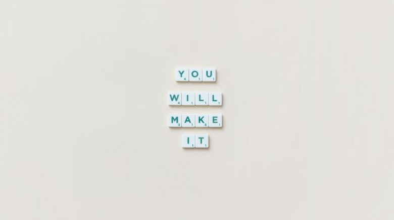 Motivational phrase 'You Will Make It' made from Scrabble tiles on a neutral background.